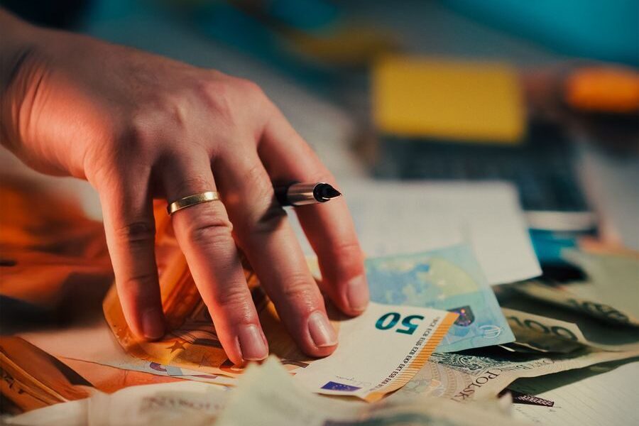 Cash banknotes and a pen on a desk